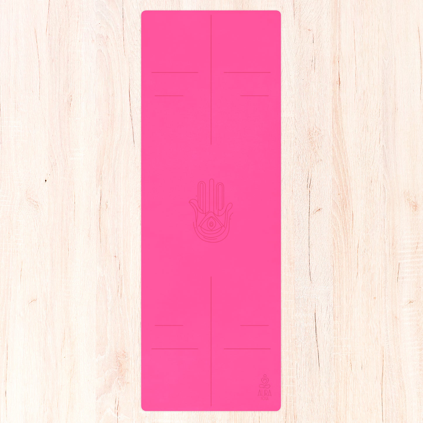 Bright pink suede yoga mat with hamsa hand line art in the center and alignment lines