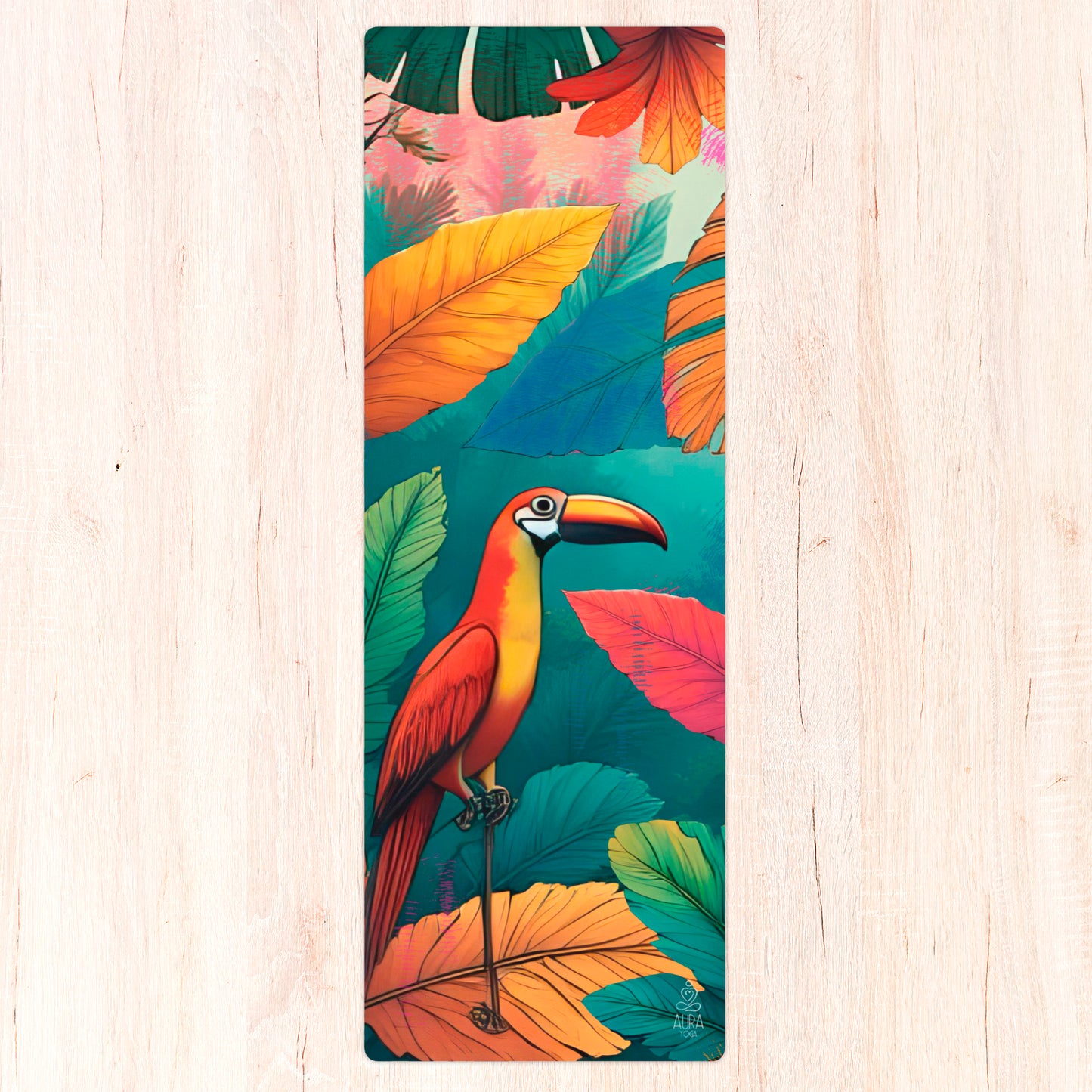 Yoga mat with a colorful tropical bird and leaf design on a wooden surface