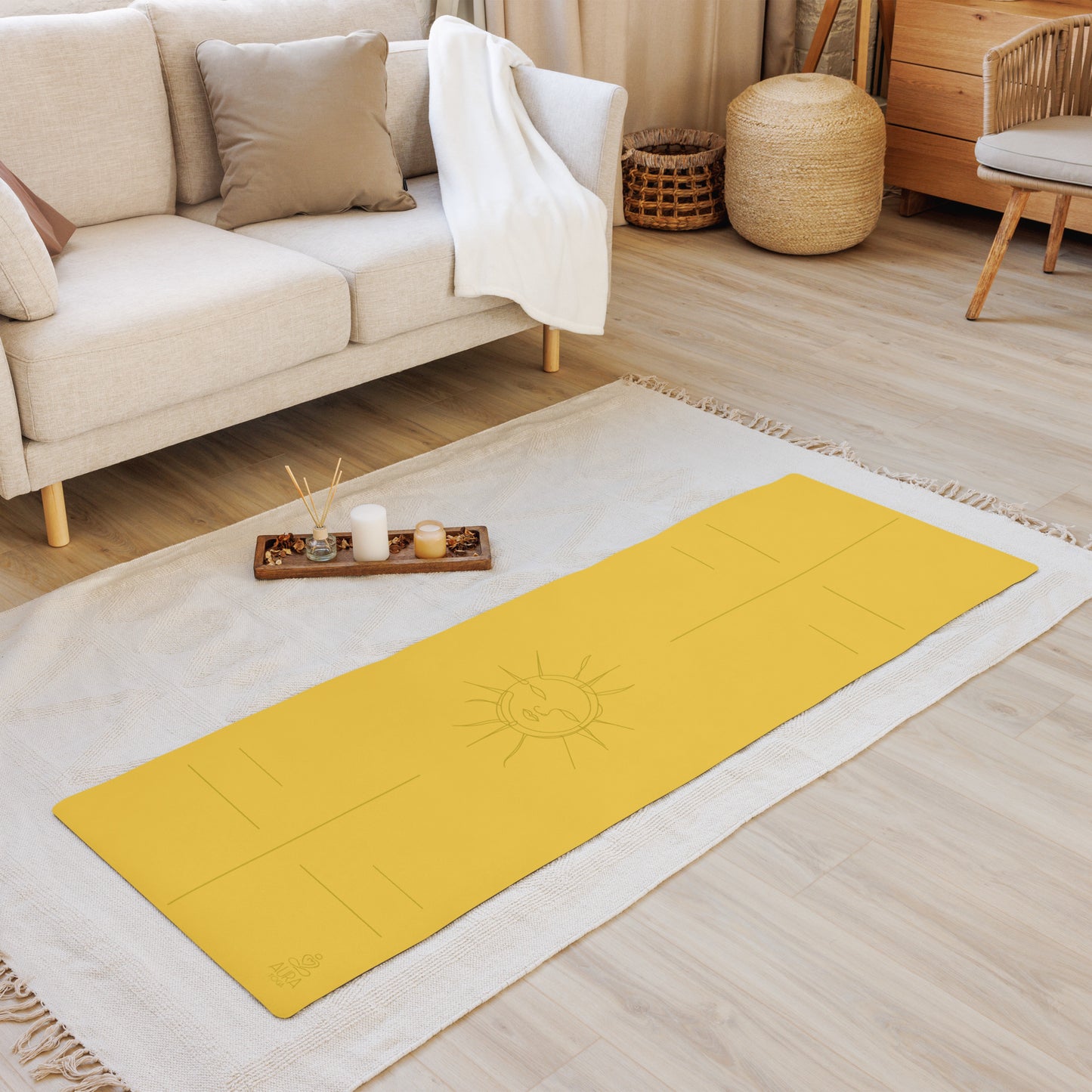Yellow suede yoga mat with a sun design and alignment lines in the center of the room on a carpet