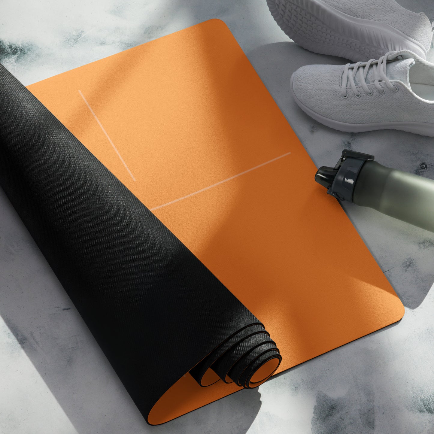 Rolled orange suede yoga mat with alignment lines