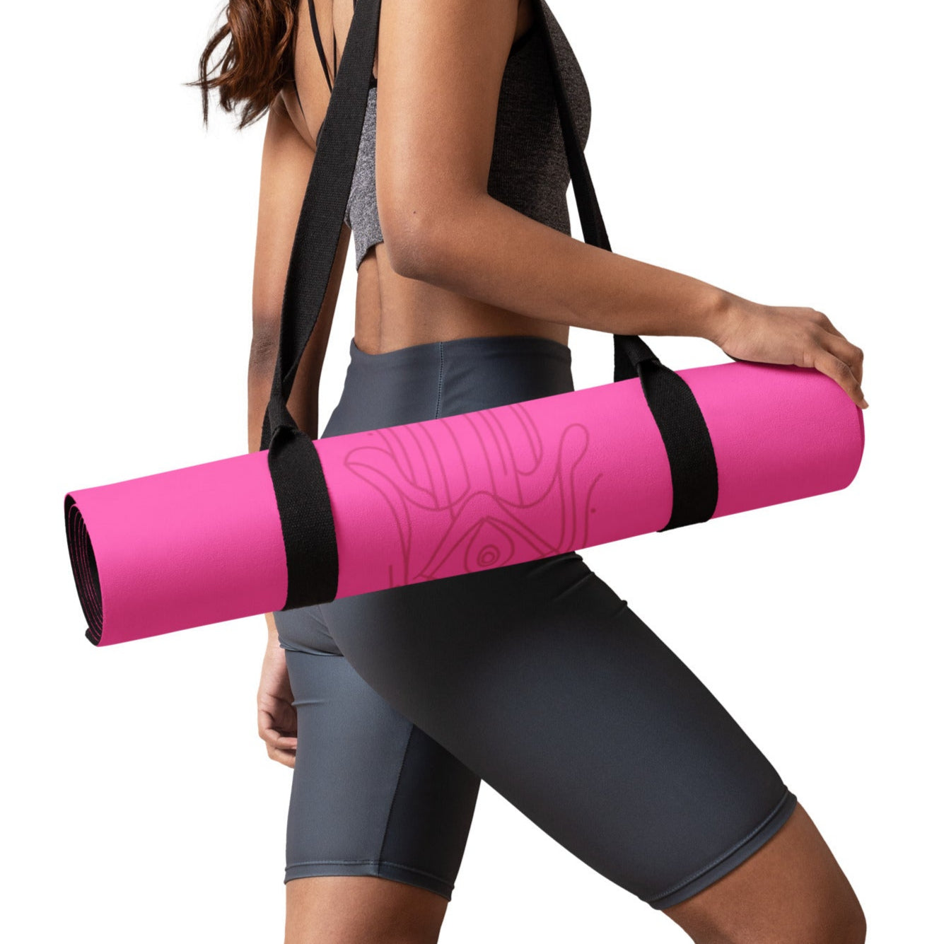 Woman carrying bright pink suede yoga mat in a yoga mat strap