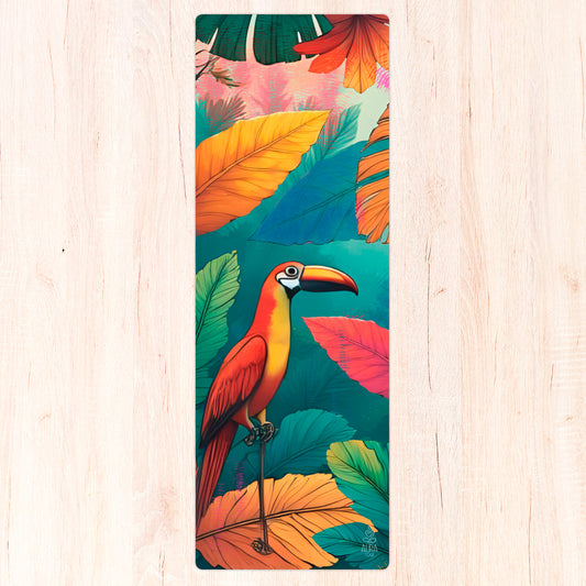 Yoga mat with a colorful tropical bird and leaf design on a wooden surface